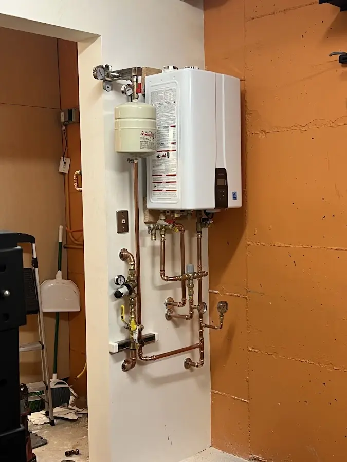 Plumbing technician inspecting water heater connections in Clearlake